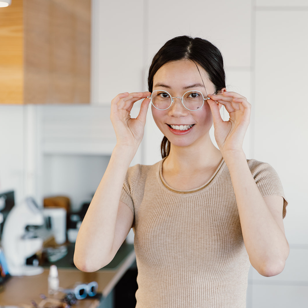 Woman trying on frames in store